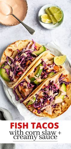 fish tacos with corn, slaw and creamy sauce on a white platter