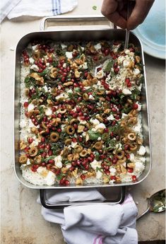 a pan filled with rice and vegetables on top of a table