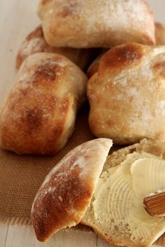 some bread and butter on a wooden table