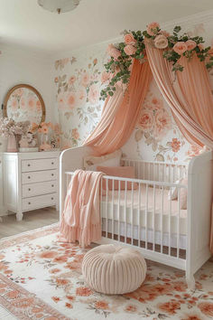 a white crib with pink curtains and flowers on the wall