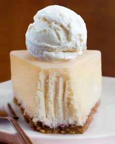 a piece of cheesecake with ice cream on top