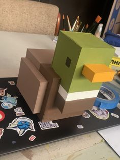 an animal made out of cardboard sitting on top of a table