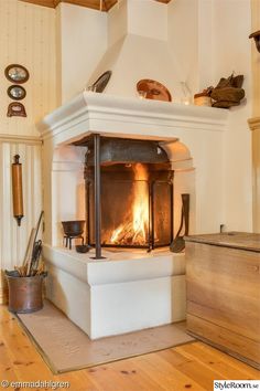 an old fashioned fireplace with wood burning in it