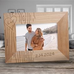 a wooden photo frame with a couple holding each other and the words love is written on it