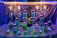 a table topped with lots of bottles and candles