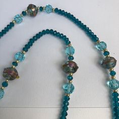 a blue beaded necklace with glass beads