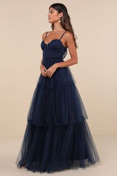 a woman in a long blue dress with spaghetti top and tiered tulle skirt