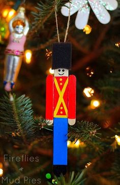 a wooden nutcracker ornament hanging from a christmas tree