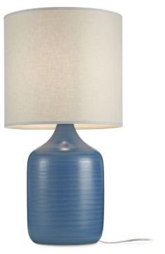 a blue table lamp with a white shade on the base and a cord attached to it