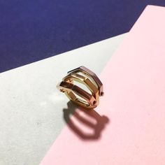 Ring play. This versatile ring brings together a multi-metal, multi-dimentional, multi-shaped piece that is irresistible to wear---and play with all day. Featuring a hexagon shape in yellow, pink, and white sterling silvers. Tap now to shop! #Minimalistic #Simple #Chic #Elegant #Luxury #Modern #nyc #Fashion #Classy #Trendy #Jewelry #collections #new #style #ring #accessories #silver #gold #bold #gift #design Modern Yellow Gold Metal Midi Rings, Modern Yellow Gold Midi Rings, Modern Yellow Gold Rings, Modern Double Band Rose Gold Rings, Modern Rose Gold Double Band Rings, Flip Ring, Ring Accessories, Accessories Silver, Gift Design