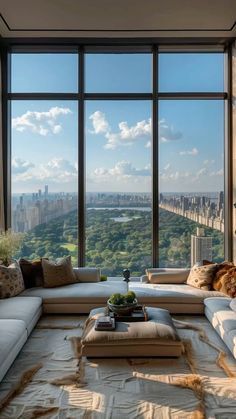 a living room filled with lots of furniture and large windows overlooking the cityscape