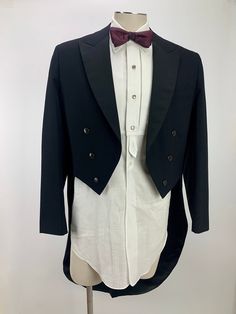 a tuxedo jacket with a bow tie on a mannequin