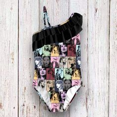 a bathing suit with pictures of marilyn monroe on the front and sides, hanging against a white wooden wall