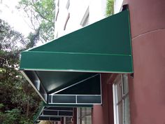 a green awning on the side of a building