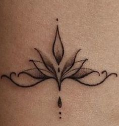 a woman's stomach with a tattoo design on it