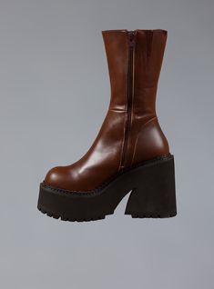 The Parker Platform Boot has a soft leather upper with side zip and a chunky platform sole that measures 1.75" in front and 4.25" at the heel. Lined inside with leather as well. SHOES ARE LISTED IN U.S. WOMEN'S SIZES. Click Here for a printable size chart (make sure you print at Actual Size to ensure accuracy) For any questions about sizing please reach out to our team ~ help@unifclothing.com Imported SKU: UWBO-1058 70s Fashion Boots, Platform Brown Boots, How To Style Platform Boots, Vampire Glamour, Brown Chunky Boots, Unif Parker Boots, Fashion Combat Boots, Womens Platform Shoes, Brown Leather Wedge Boots