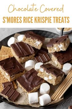 chocolate covered s'mores rice krispie treats on a plate with chopsticks