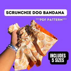 a hand holding up a piece of food with the words scrunche dog bandana on it