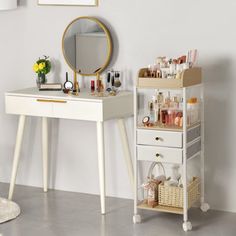 a white vanity table with drawers and a mirror