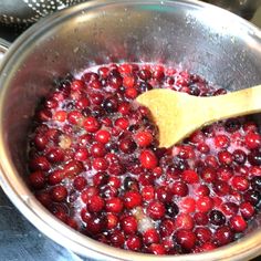 cranberry sauce in a pot with a wooden spoon