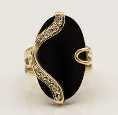 "\"Oval Onyx Splendor 14K Gold Estate Ring with 10 Diamonds\" Description: Presenting the \"Oval Onyx Splendor 14K Gold Estate Ring,\" a one-of-a-kind masterpiece that combines the timeless beauty of onyx with the brilliance of diamonds. This custom-made ring is a true testament to elegance and individuality. Key Features: 1. Stunning Onyx Centerpiece: At the heart of this exquisite ring lies a captivating oval onyx gemstone, exuding an aura of mystique and sophistication. Its deep, lustrous bla Elegant Multi-stone Oval Cabochon Jewelry, Exquisite Oval Jewelry For Evening, Gold Oval Multi-stone Jewelry, Fine Jewelry Oval Evening Jewelry, Gold Multi-stone Oval Cabochon Ring, Oval Multi-stone Jewelry For Formal Occasions, Exquisite Oval Rings For Evening, Oval Jewelry With Polished Finish For Evening, Oval Stone Setting Jewelry For Formal Occasions