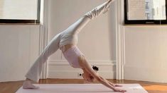 a woman is doing yoga on a mat