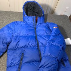 Brand New W/ All Tags Attached. Blue. High Quality Details. Fitted Casual Blue Puffer Jacket, Fitted Blue Casual Puffer Jacket, Blue Down Outerwear For Outdoor, Fitted Blue Tommy Hilfiger Outerwear, Casual Blue Down Outerwear, Blue Tommy Hilfiger Outerwear With Pockets, Tommy Hilfiger Blue Outerwear For Fall, Blue Down Puffer Jacket With Pockets, Fitted Blue Outerwear For Outdoor