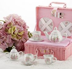 pink and white porcelain tea set with matching basket