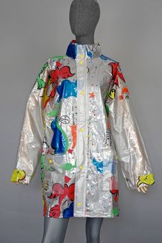 "Features: - 100% Authentic JC de CASTELBAJAC. - PVC raincoat with vibrant Pop Art prints. - High neckline and 2 front pockets. - Yellow stud buttons with Castelbajac iconic logo. - Signed \"Breakfast Time\" JC de CASTELBAJAC. - Size Small. - Material composition: 100% PVC (Outer), 100% PVC (Lining). - Comes with its original back bag. - Excellent vintage condition. Measurements taken laid flat, please double bust and hips: RAINCOAT Sleeves: 30.51 inches (77.5 cm) from collar to end of sleeves B Multicolor Long Sleeve Rainy Weather Outerwear, Multicolor Long Sleeve Outerwear For Rainy Weather, Multicolor Long Sleeve Rain Jacket, Multicolor Hooded Raincoat For Fall, Multicolor Long Sleeve Raincoat For Fall, Multicolor Raincoat For Rainy Weather In Fall, Casual Multicolor Raincoat For Fall, Multicolor Outerwear For Rainy Fall Weather, Multicolor Fall Outerwear For Rainy Weather