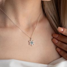 This unique snowflake necklace with birthstones is the perfect way to show your loved ones how much you care. The snowflake is a symbol of winter beauty and uniqueness, just like the person you are giving it to. The birthstone adds a personal touch, making the necklace even more special. The necklace is made of high-quality sterling silver and features a delicate snowflake pendant with a sparkling birthstone of your choice.  This necklace is perfect for any occasion, whether it's a birthday, ann Snowflake Cubic Zirconia Jewelry For Anniversary, Cubic Zirconia Snowflake Jewelry For Anniversary, Anniversary Snowflake Cubic Zirconia Jewelry, Snowflake Necklace For Christmas Anniversary, Christmas Gift Cubic Zirconia Necklace, Christmas Snowflake Necklace For Anniversary, Cubic Zirconia Necklace For Christmas, White Cubic Zirconia Snowflake Necklace, White Snowflake Jewelry For Anniversary