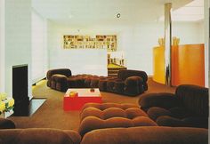 a living room filled with lots of brown furniture