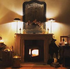 a living room filled with furniture and a fire place next to a mirror on the wall