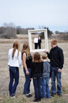 a group of people standing in front of a mirror