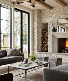 a living room filled with furniture and a fire place in the middle of it's walls