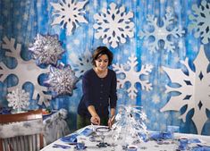 a woman standing in front of a table with snowflakes on it