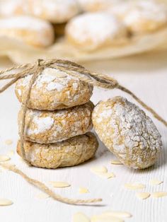 a stack of cookies sitting next to each other on top of a white table covered in powdered sugar