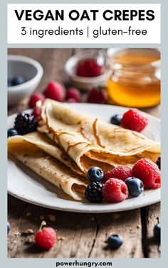 a white plate topped with crepes covered in fruit