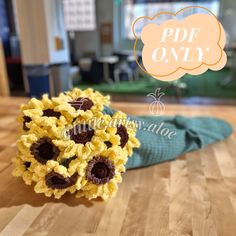 a bouquet of sunflowers sitting on top of a wooden table