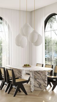 an elegant dining room with marble table and chairs in front of large windows, along with round pendant lights hanging from the ceiling