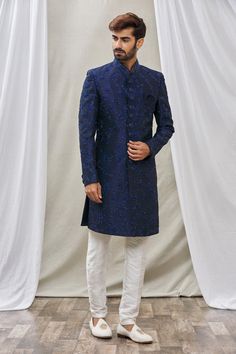 Blue sherwani with floral embroidery and mandarin collar. Paired with pant.
Component: 2
Pattern: Embroidered
Type Of Work: Floral
Neckline: Mandarin
Sleeve Type: Full Sleeves
Fabric: Art Banarasi Silk, Dupion Art Silk
Color: Blue
Other Details: 
Floral embroidery
Front buttons
Note: Pocket square worn by the model is not for sale
Occasion: Sangeet - Aza Fashions Formal Blue Salwar Kameez With Intricate Embroidery, Blue Semi-stitched Traditional Wear For Formal Occasions, Elegant Blue Jamawar Kurta, Festive Blue Jamawar Kurta, Blue Chikankari Embroidery Traditional Wear For Reception, Blue Traditional Wear With Chikankari Embroidery For Reception, Semi-stitched Blue Kurta For Ceremonial Occasions, Blue Semi-stitched Kurta For Ceremonial Occasions, Blue Unstitched Suit With Chikankari Embroidery For Reception