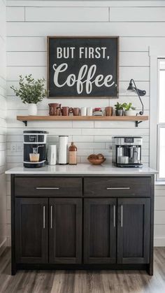 a kitchen with black and white cabinets, a sign that says but first coffee on the wall