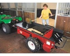 a woman is cleaning the floor in front of a red cart with a mower