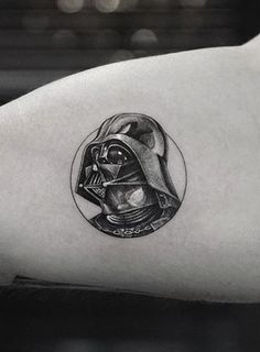 a tattoo on the arm of a person with a darth vader helmet in it