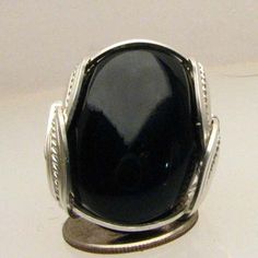 "Handmade Sterling Silver Wire Wrap Black Onyx Ring Sizing and shipping is ALWAYS FREE with a 14 day \"No Questions Asked\" return policy. Gemstone sizes available: XS (16x12mm 5/8x1/2 inch) S (18x13mm 3/4x1/2 inch 10+ct) M (25x18mm 1x3/4 inch 20+ct) L (30x22mm 11/8 x7/8 inch 25+ct) *In the notes section of your order, please specify ring size and gemstone size (XS-S-M-L).* This ring is made with real gems. I made it myself, so if you see a setting you like and want a different gem in it, I can Vintage Black Oval Cabochon Ring, Black Oval Cabochon Jewelry, Oval Black Cabochon Jewelry, Oval Onyx Cabochon Ring, Oval Cabochon Onyx Ring, Handmade Oval Onyx Rings, Oval Onyx Ring With Cabochon, Family Jewellery, Sterling Silver Wire Wrap