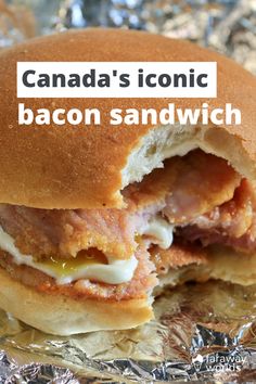 the bacon sandwich has been cut in half and is sitting on tin foil with text that reads, canada's iconic bacon sandwich