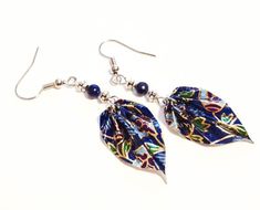 Hand made with 100% authentic Japanese Washi paper. These Lapis Lazuli floral leaf earrings are sealed in 5 coats of protective polymer to make them water resistant and durable. The accent beads are metal and lapis lazuli. These floral origami leaf earrings measure 2.5 Inches from ear to bottom of the leaf and the leaf itself measures and 1 Inch in length and 0.5 in diameter. All metals used in construction of these leaf earrings are nickel-free for sensitive ears.Note: It is not recommended to Multicolor Leaf Shaped Earrings Gift, Multicolor Leaf Earrings For Gift, Multicolor Leaf-shaped Earrings For Gift, Multicolor Leaf Earrings Gift, Floral Origami, Origami Leaf, Origami Leaves, Earrings Paper, Origami Earrings