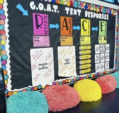 a classroom bulletin board with colorful pom poms