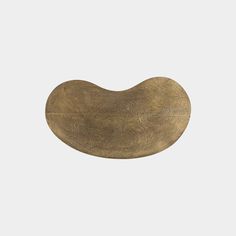 an oval brass plate on a white background