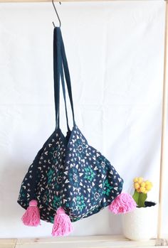 This handmade shoulder bag is a true piece of art, featuring intricate hand-stitching a unique bohemian design, and a four-sided (tetrahedral) base, giving it a distinct and geometric look. Crafted with care by our artisans. This bag is perfect for anyone who loves unique and beautiful accessories.  With its charming tassels and original design, this bag is sure to be a standout addition to any wardrobe. Unique Design: Every bag boasts a distinct pattern, with subtle variations in details, makin Handmade Blue Bohemian Hobo Bag, Bohemian Ethically Sourced Bags, Bohemian Blue Hobo Tote Bag, Bohemian Shoulder Bag With Removable Pouch For Market, Blue Bohemian Pouch Shoulder Bag, Bohemian Blue Shoulder Bag For Market, Blue Bohemian Shoulder Bag For Market, Handmade Bohemian Hobo Pouch Bag, Bohemian Ethically Sourced Shoulder Bag For Travel