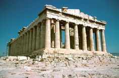 an ancient building with columns and pillars on top